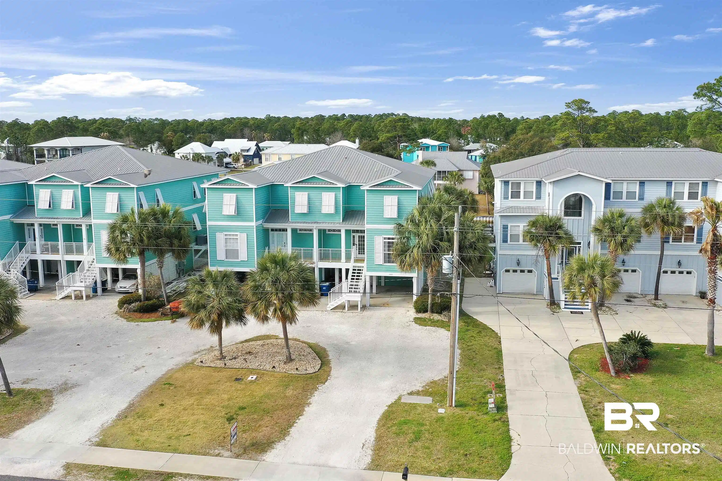 Image 1: Coastal-style architecture featuring vibrant exterior paint, multiple balconies, metal roofing, and mature palm trees