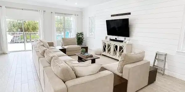 Image 3: Spacious living area featuring wood-finish flooring, recessed lighting, and a ceiling fan