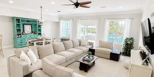 Image 4: Spacious open-concept living area featuring light wood-finish flooring and recessed lighting