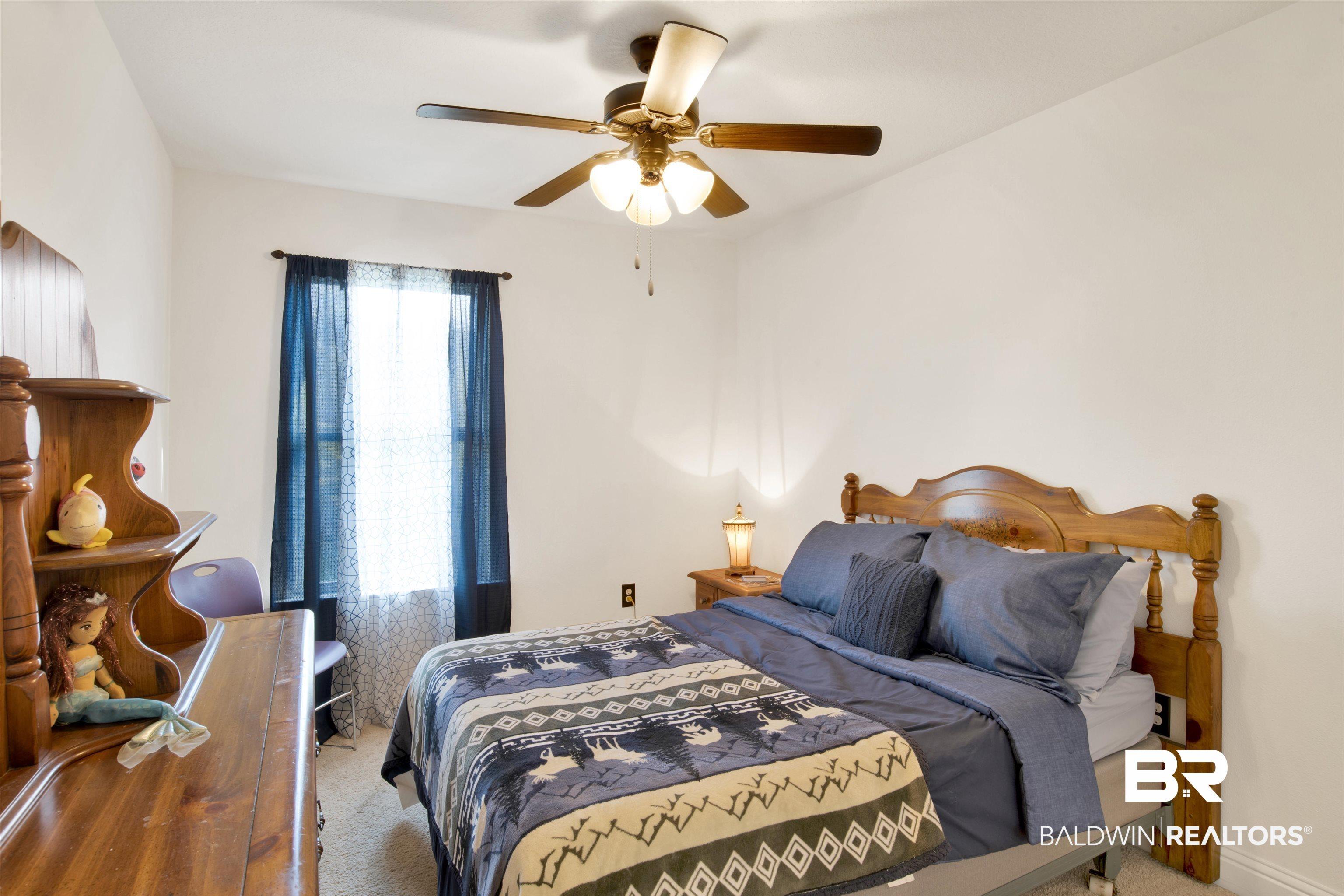 Image 3: Bedroom with carpet flooring and a ceiling fan