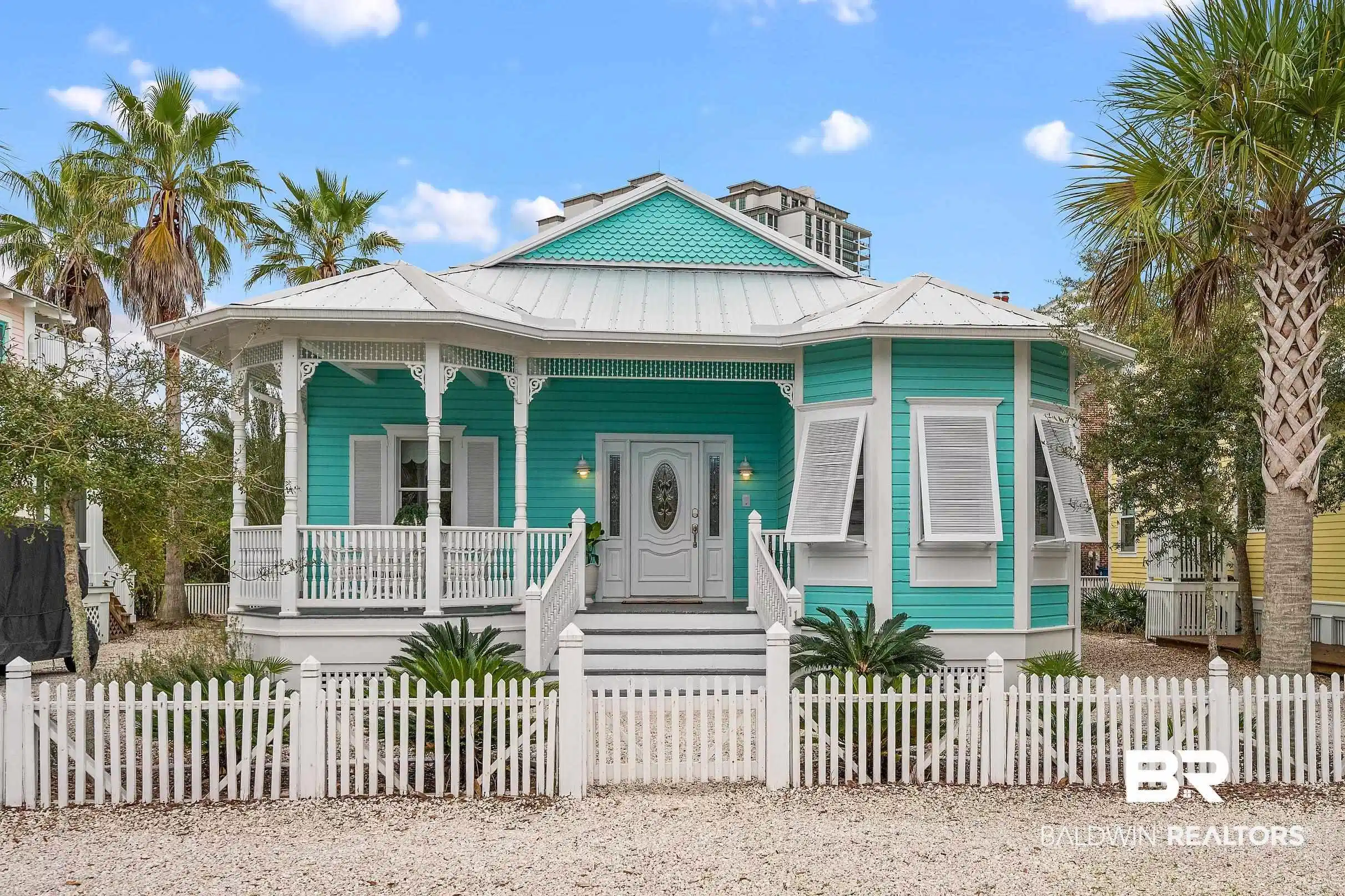 Image 1: View of front of house featuring covered porch, a standing seam roof, a metal roof, and a fenced front yard