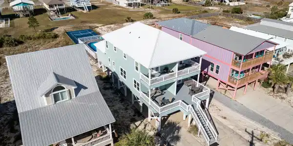 Image 2: Aerial view of residential area featuring a nearby body of water