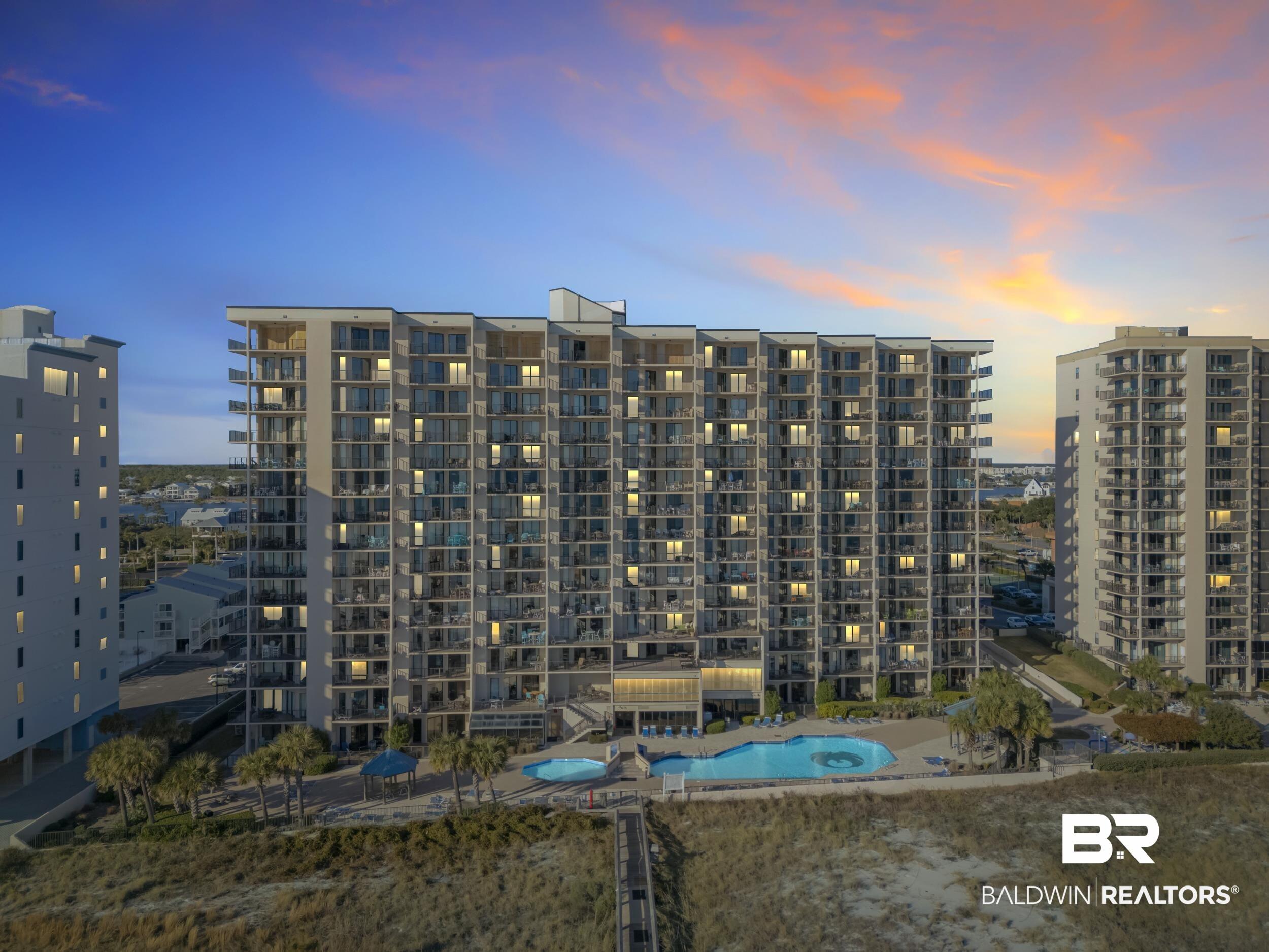 Image 1: Property at dusk with a view of apartment building / complex