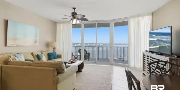 Image 2: Living room featuring floor to ceiling windows, ceiling fan, light tile patterned flooring, and a textured ceiling
