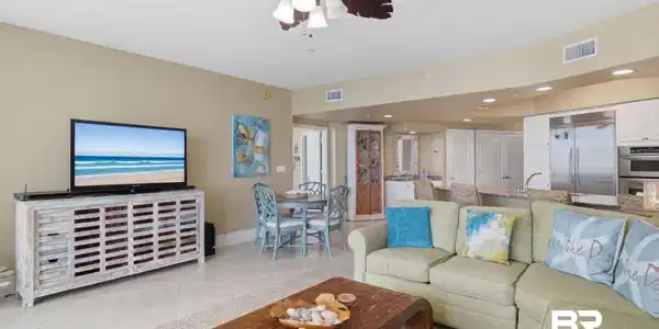 Image 4: Living area with a ceiling fan, light tile patterned floors, and recessed lighting