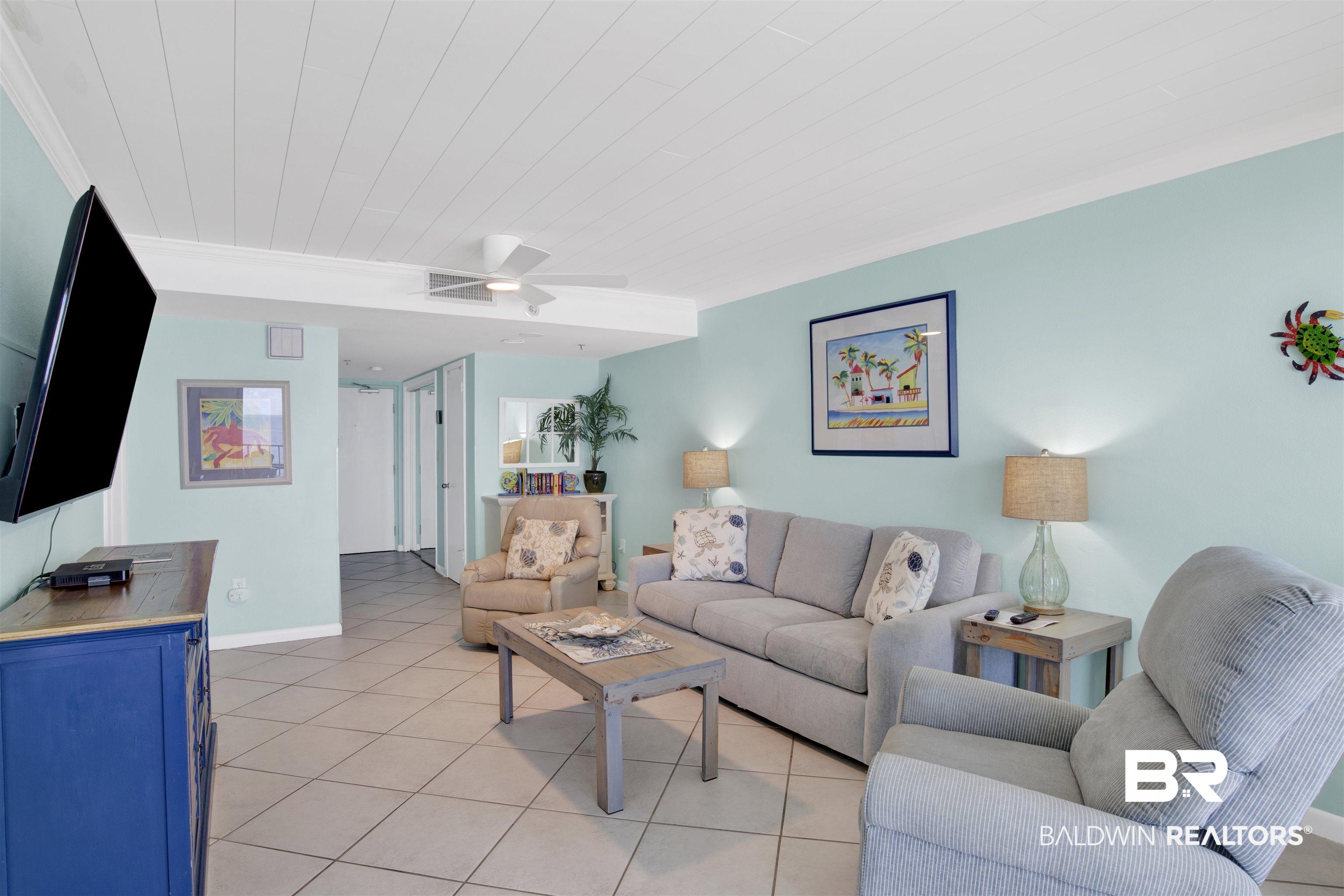 Image 4: Living area featuring light tile patterned floors, wood ceiling, and crown molding