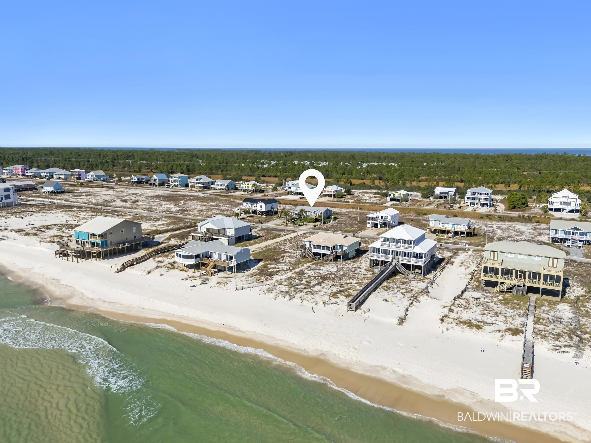 Image 3: Aerial view of residential area featuring local beach