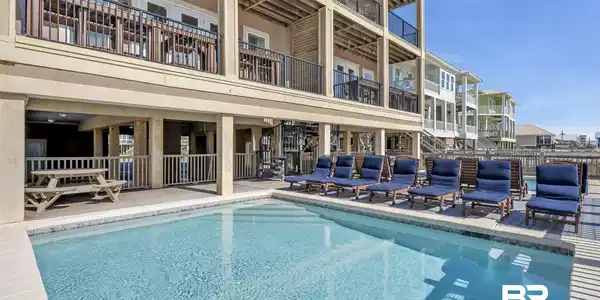 Image 3: Community pool with a patio area