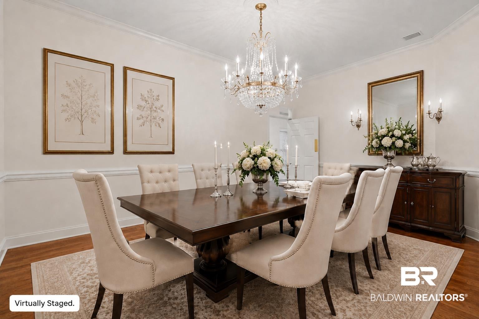 Image 3: Dining room featuring hardwood flooring, detailed crown molding, and wainscoting. This photo has been virtually staged.