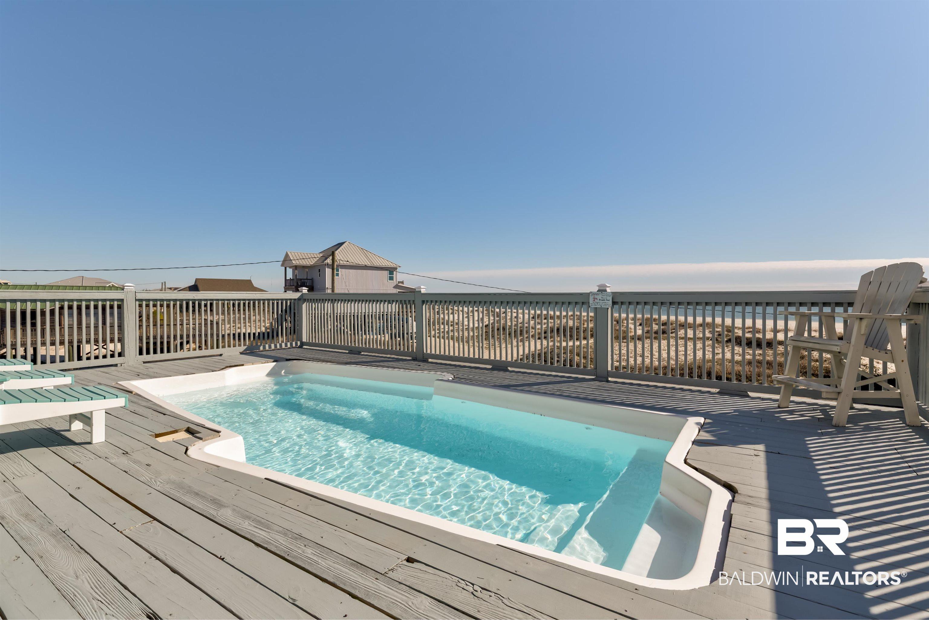 Image 4: View of swimming pool featuring a deck with water view