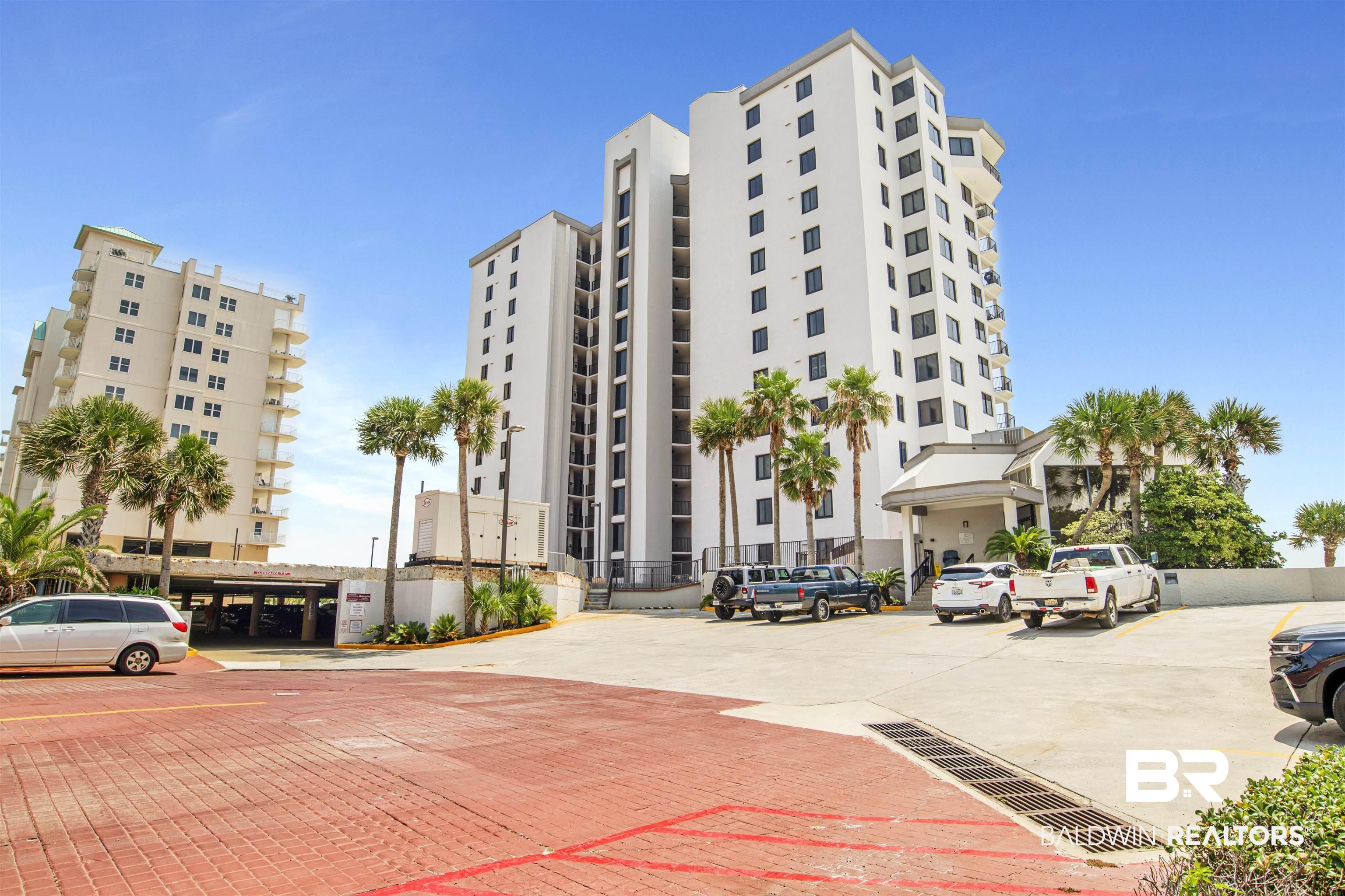 Image 2: View of apartment building / complex with uncovered parking