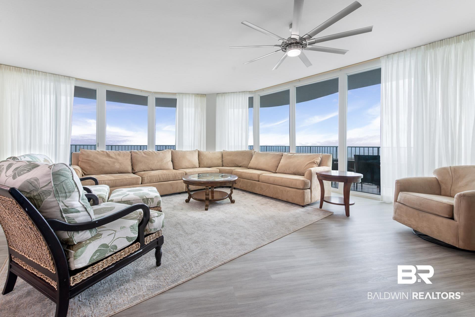 Image 2: Living room featuring plenty of natural light, light hardwood / wood-style flooring, and floor to ceiling windows