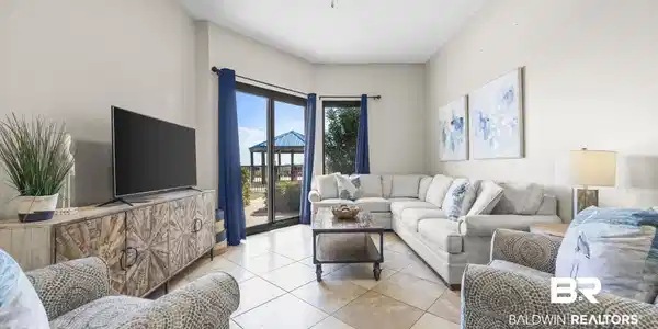 Image 2: Living room featuring light tile patterned flooring