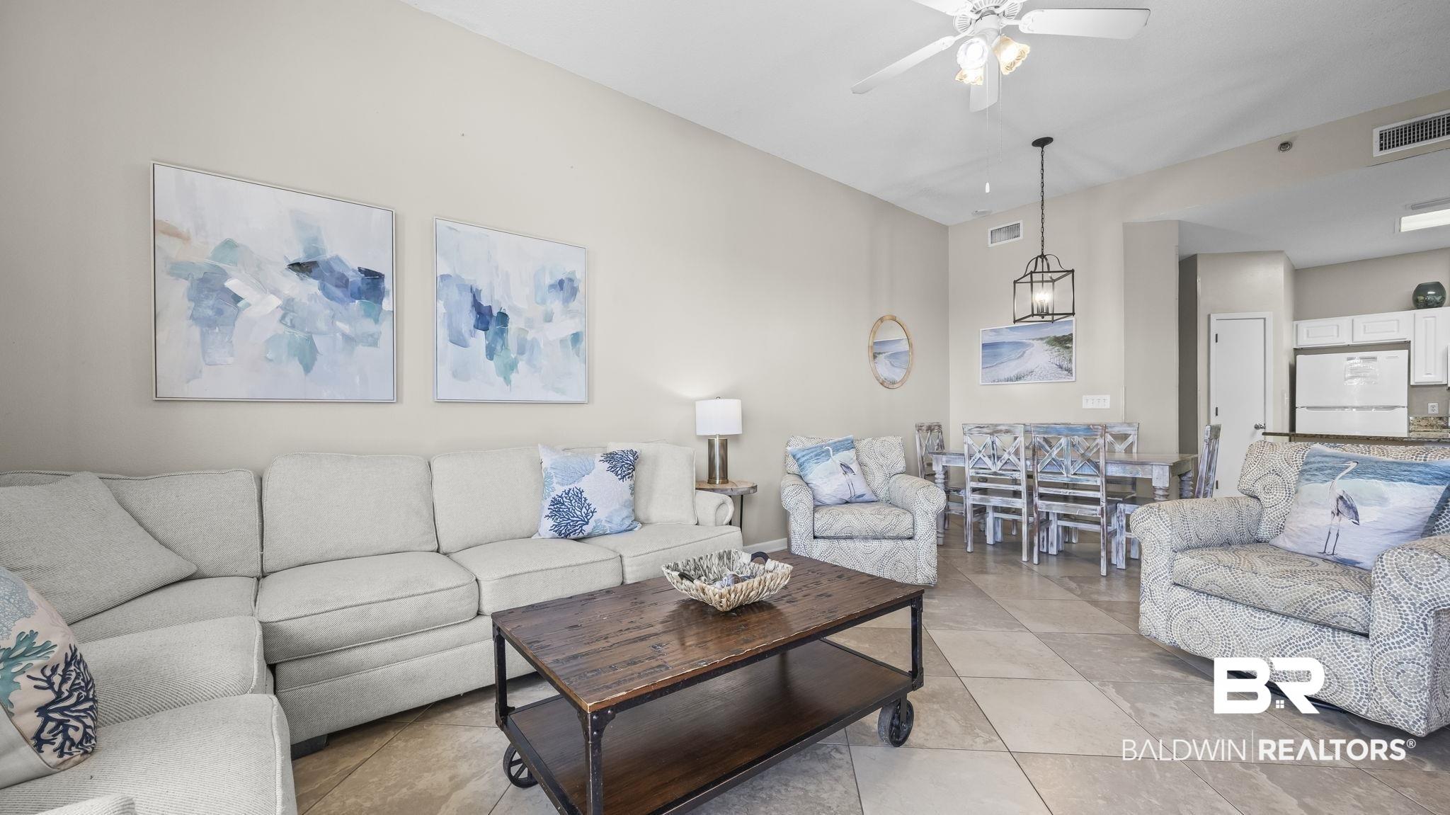 Image 3: Living room featuring a ceiling fan and light tile patterned flooring