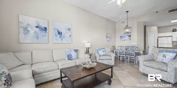 Image 3: Living room featuring a ceiling fan and light tile patterned flooring
