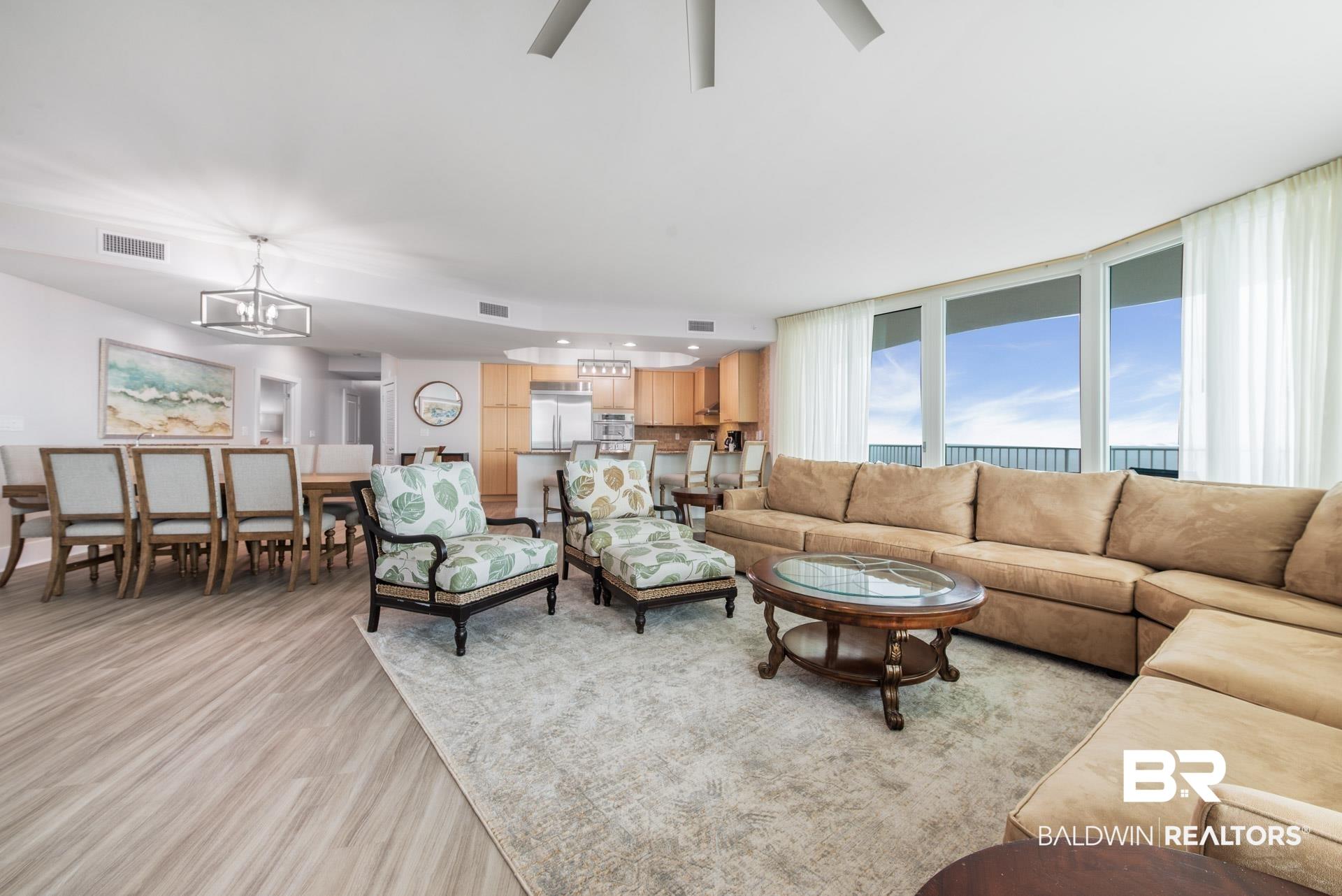 Image 3: Living room featuring a notable chandelier and light wood-type flooring