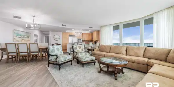 Image 3: Living room featuring a notable chandelier and light wood-type flooring