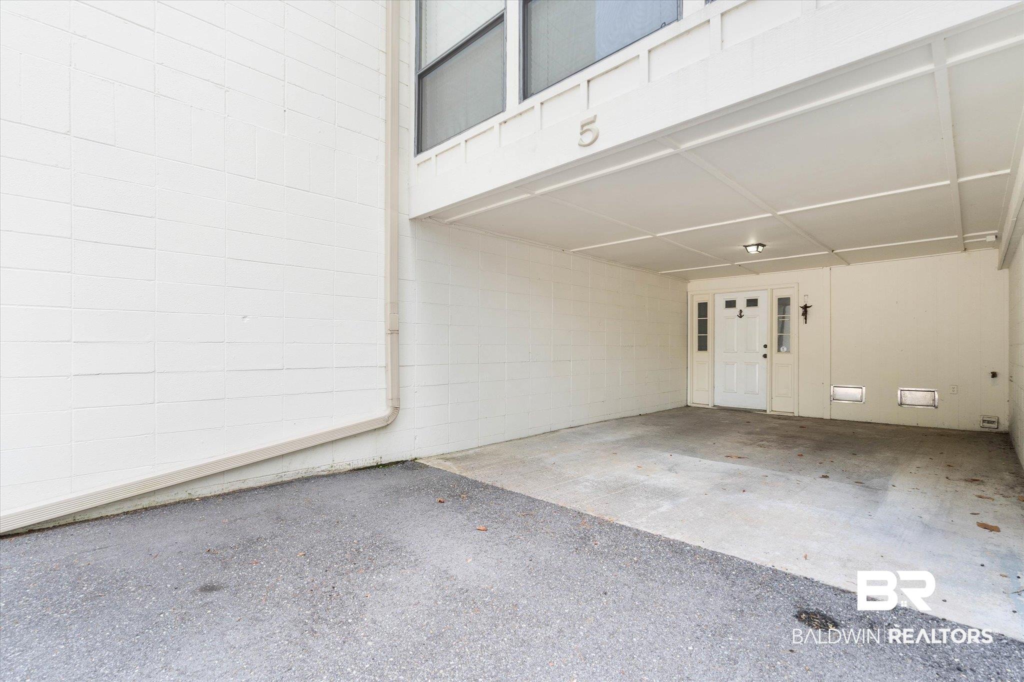 Image 2: Garage featuring an attached carport