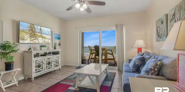 Image 2: Living area with ceiling fan, light tile patterned flooring, and a textured ceiling