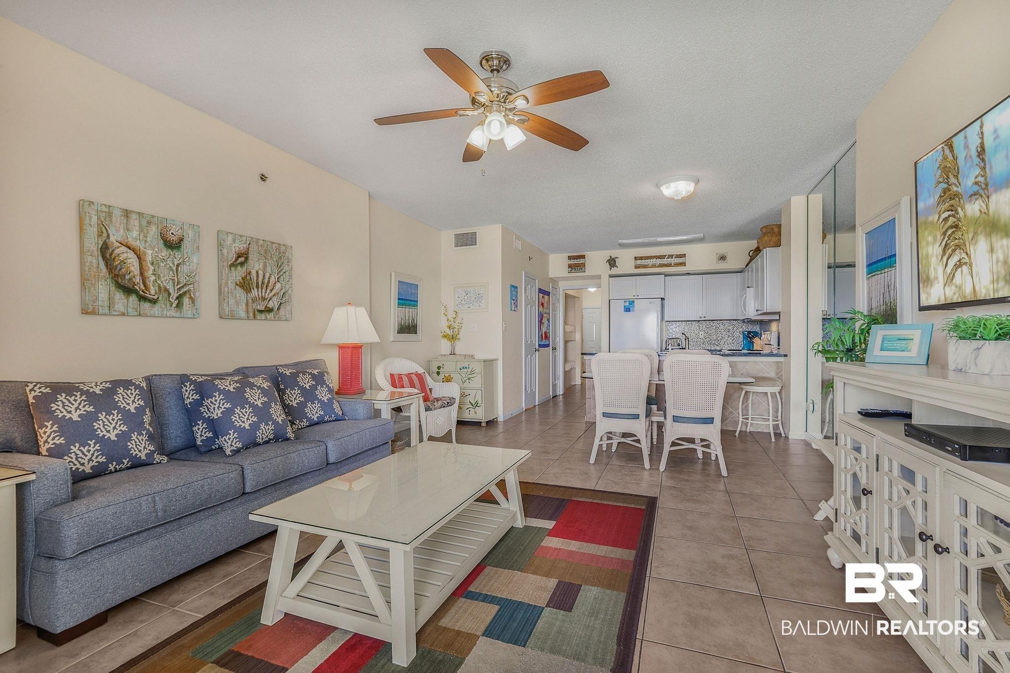 Image 4: Living room featuring a ceiling fan and light tile patterned floors