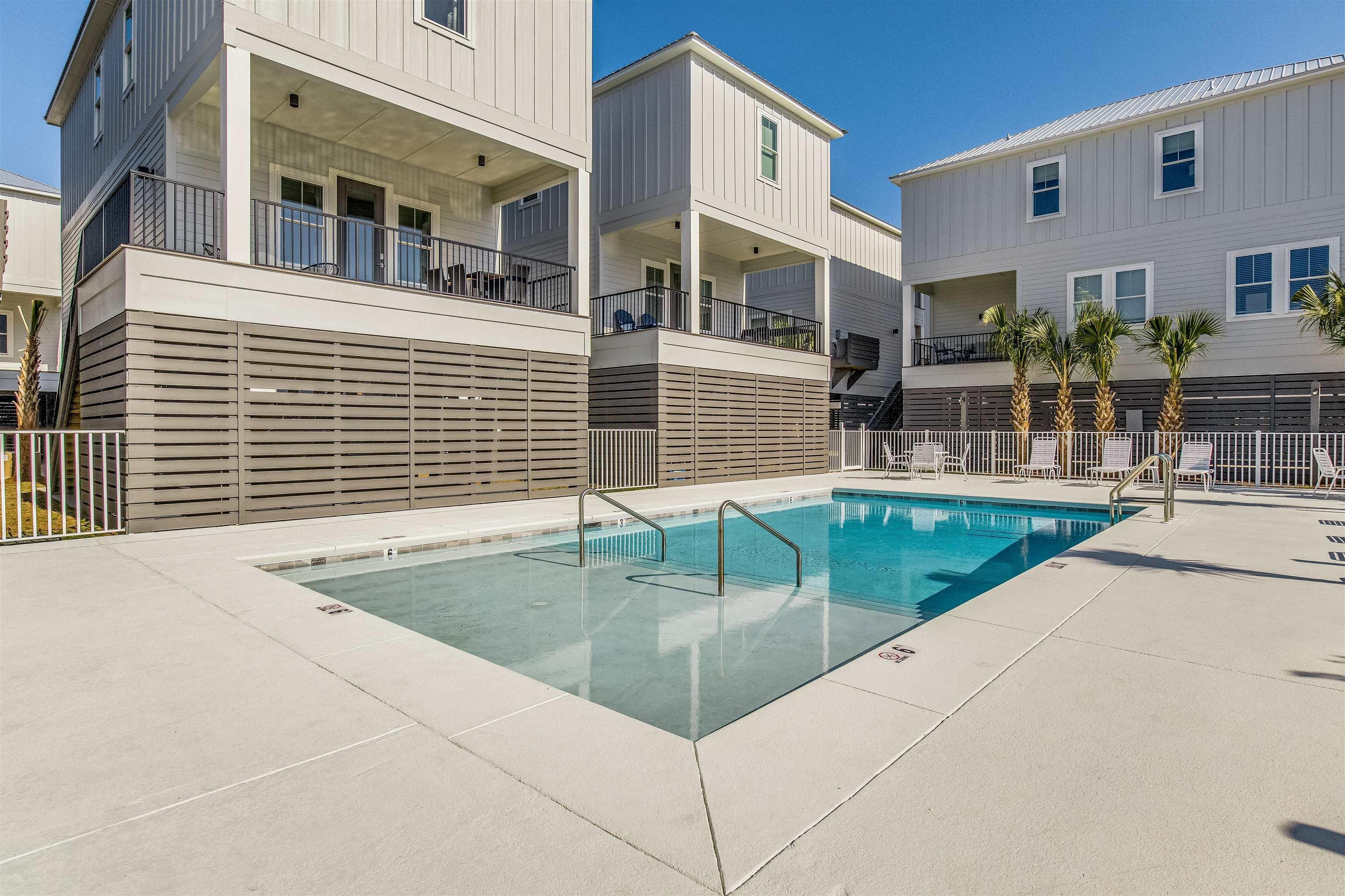 Image 1: Community pool with a patio area