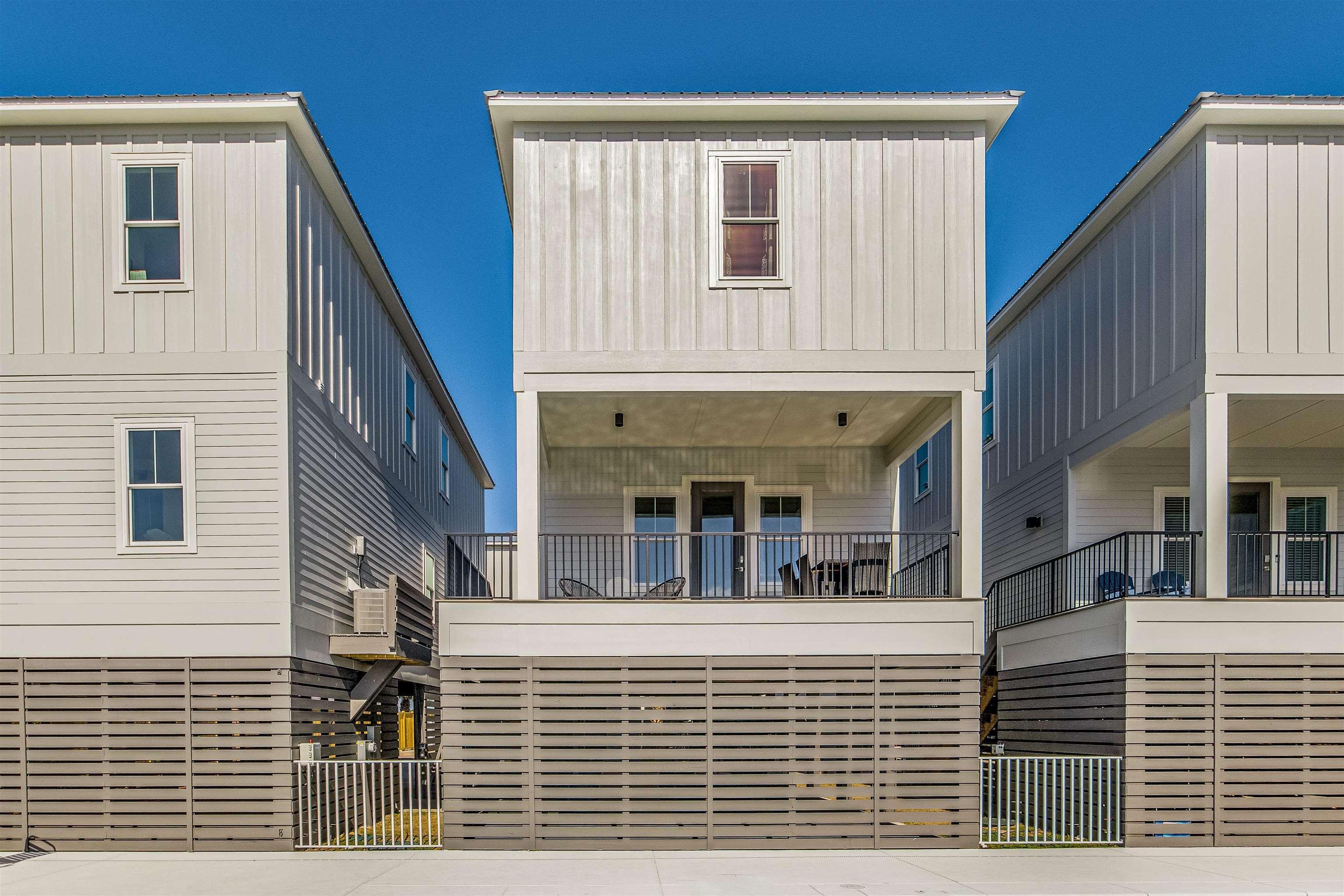 Image 2: View of front of house with board and batten siding