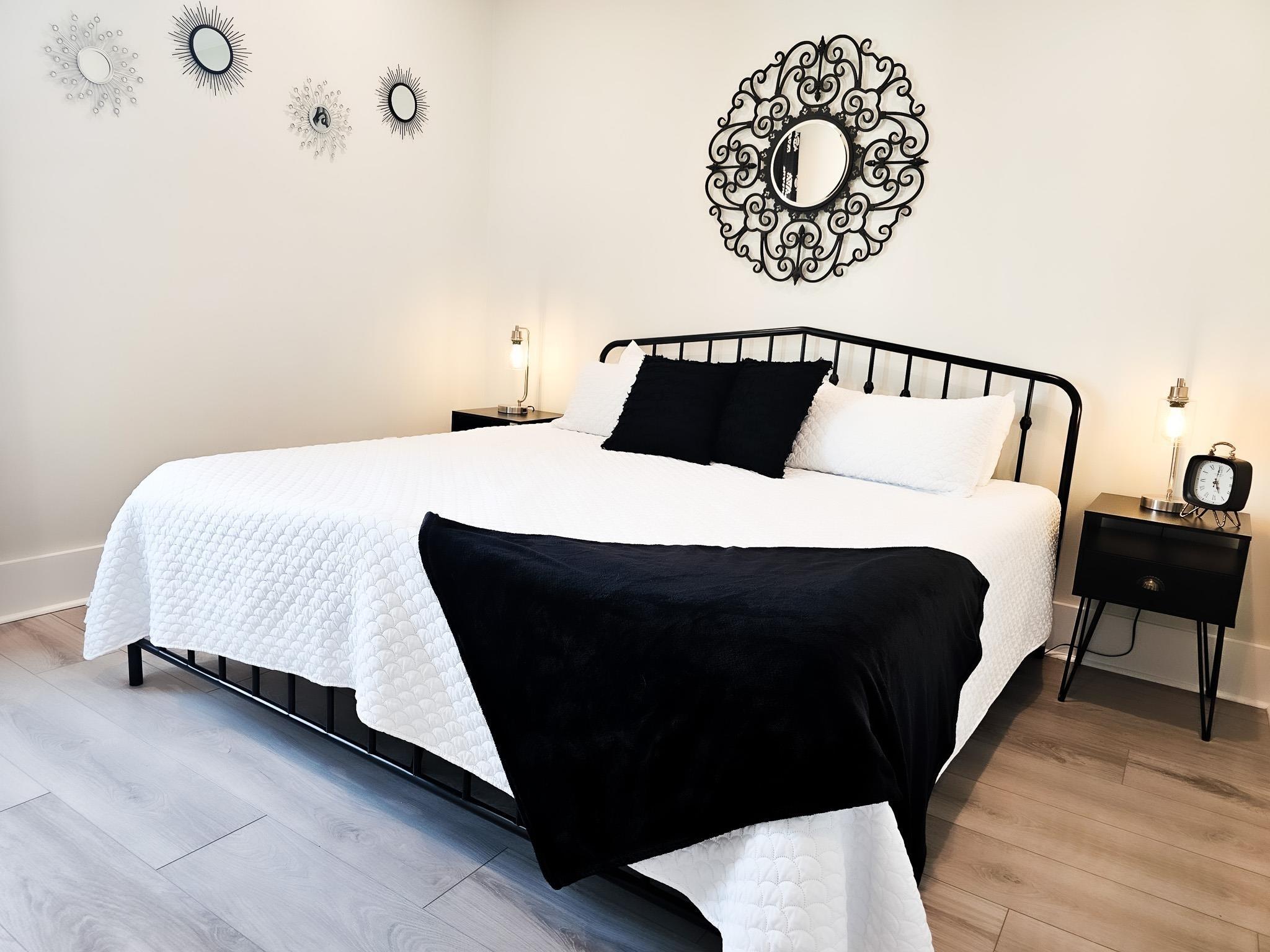 Image 3: Bedroom featuring wood finished floors and baseboards