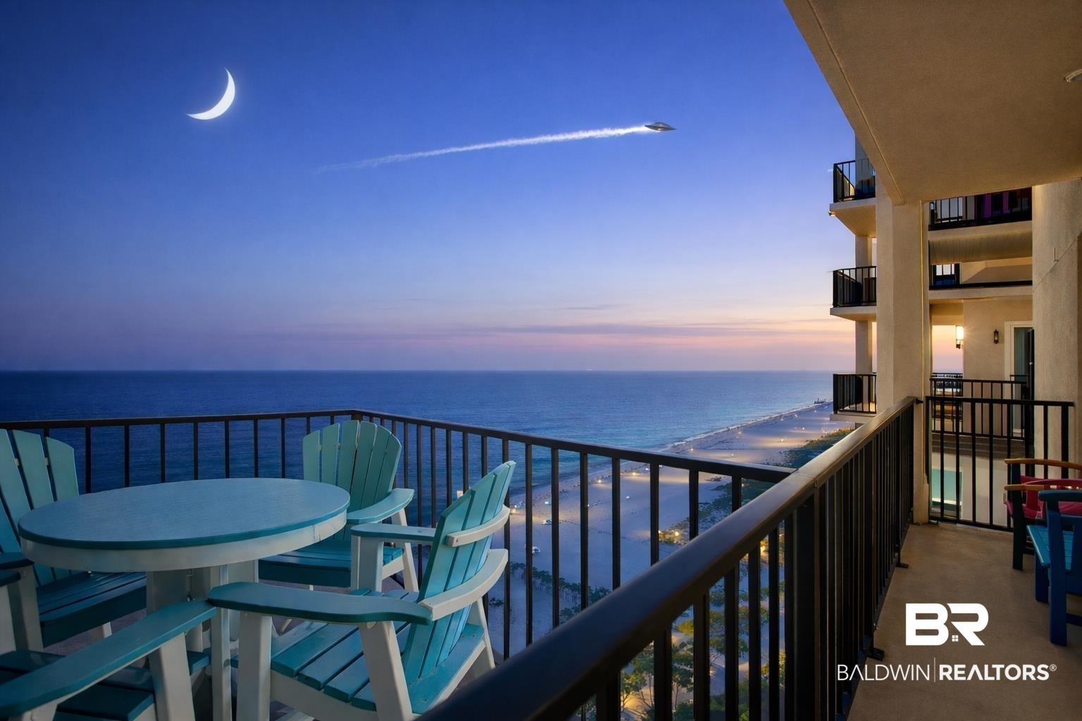 Image 2: Balcony featuring a water view