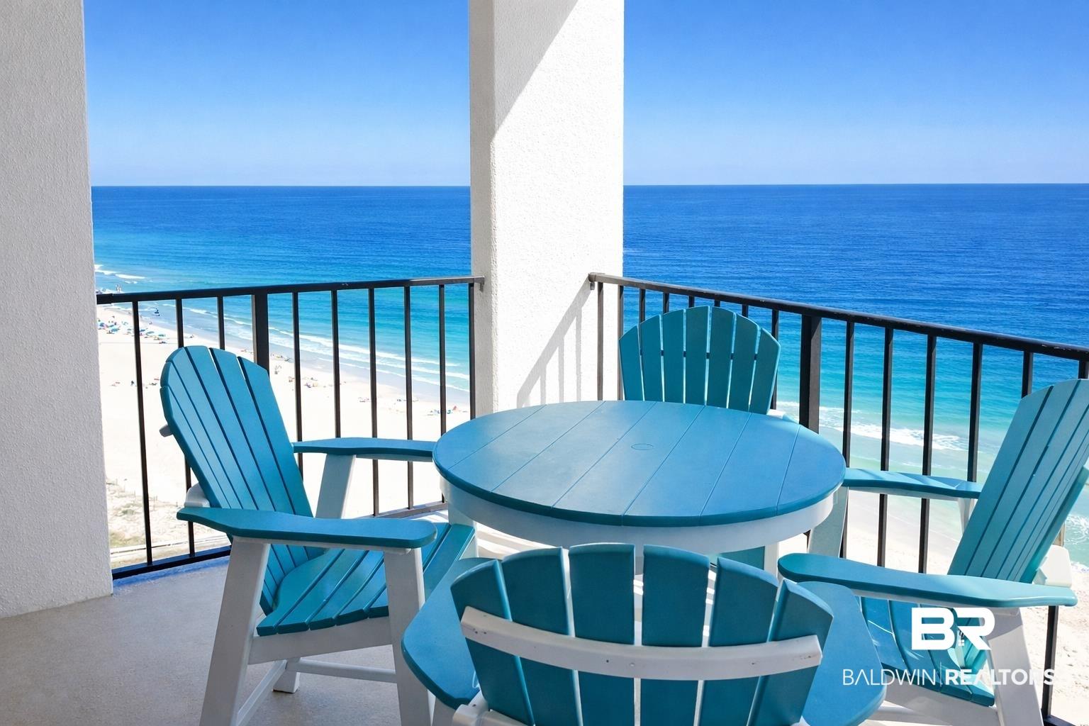Image 3: Balcony featuring view of water and beach