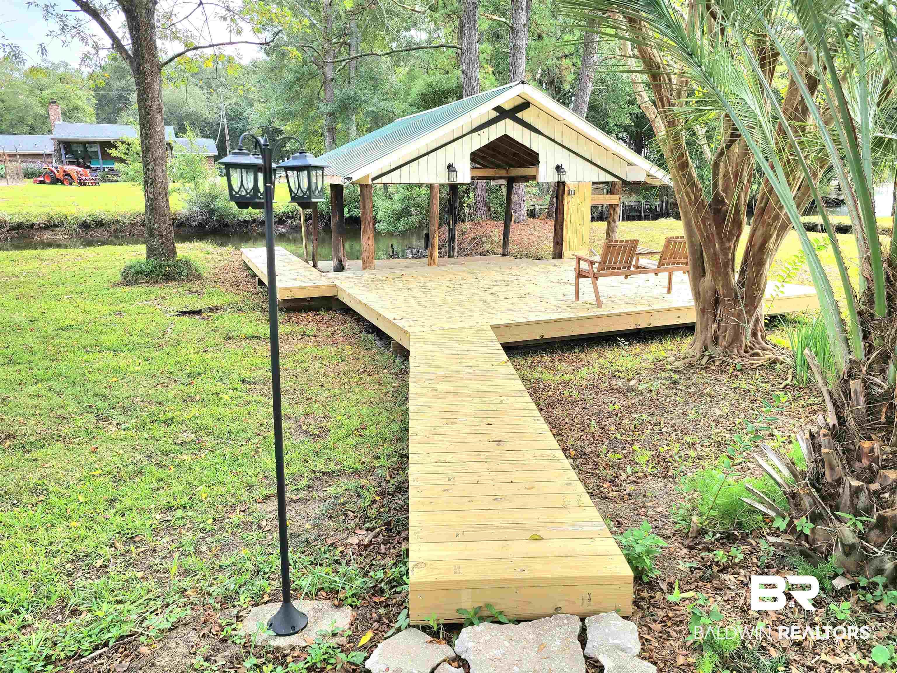 Image 4: Wooden deck featuring a lawn