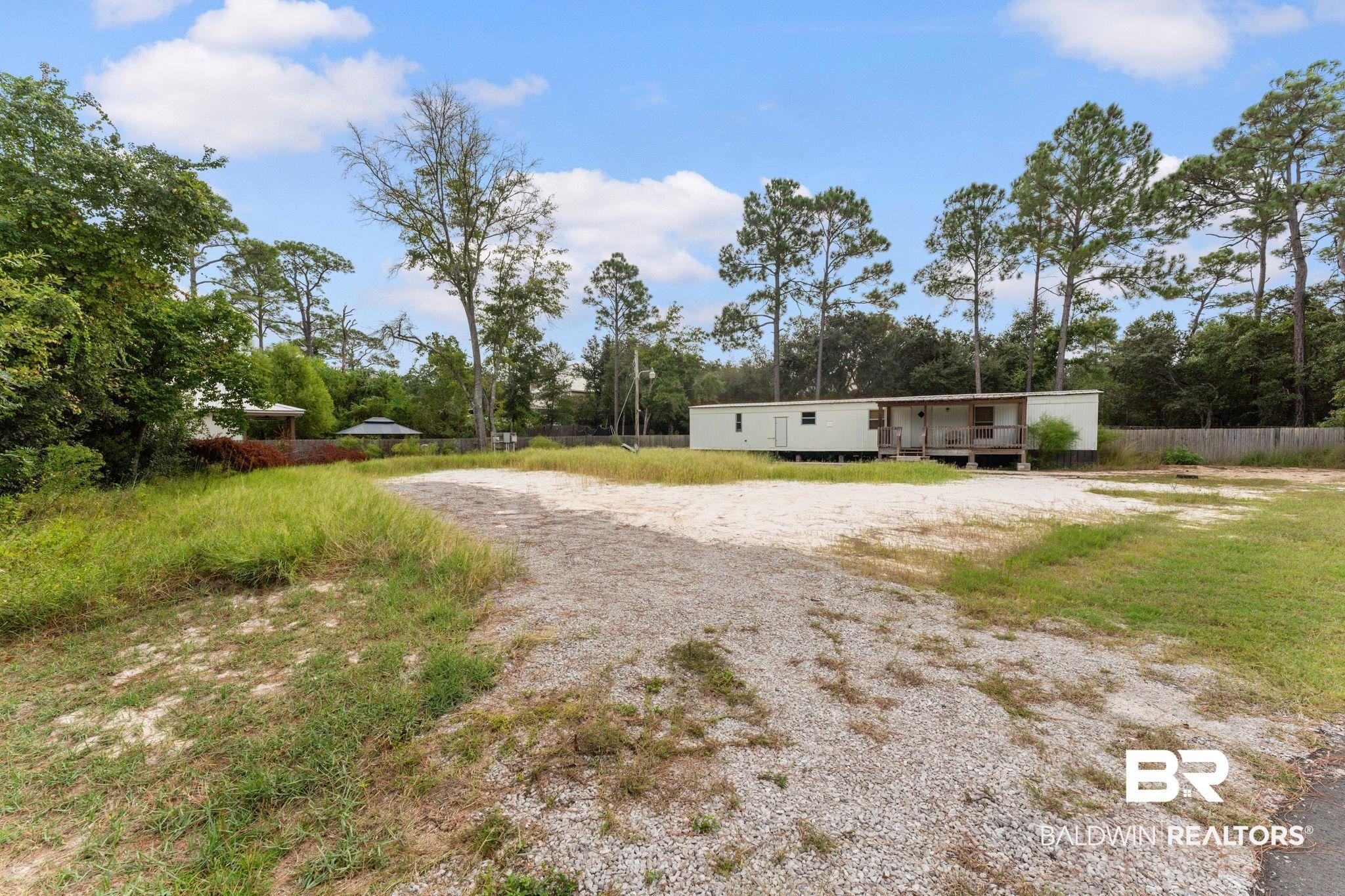 Image 3: View of front facade with driveway