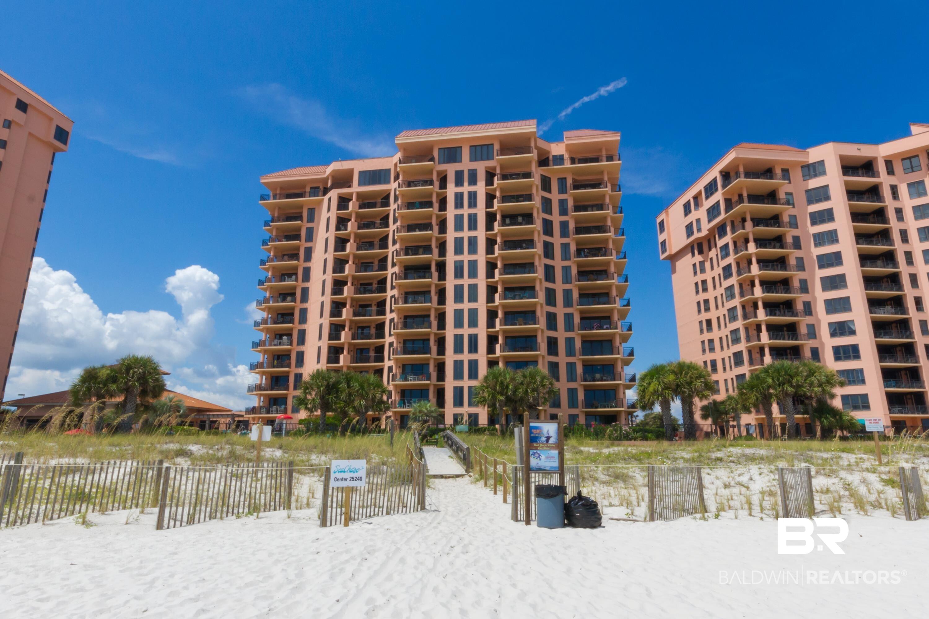 Image 1: Coastal high-rise buildings featuring multiple private balconies overlooking a white sand beach with a wooden boardwalk