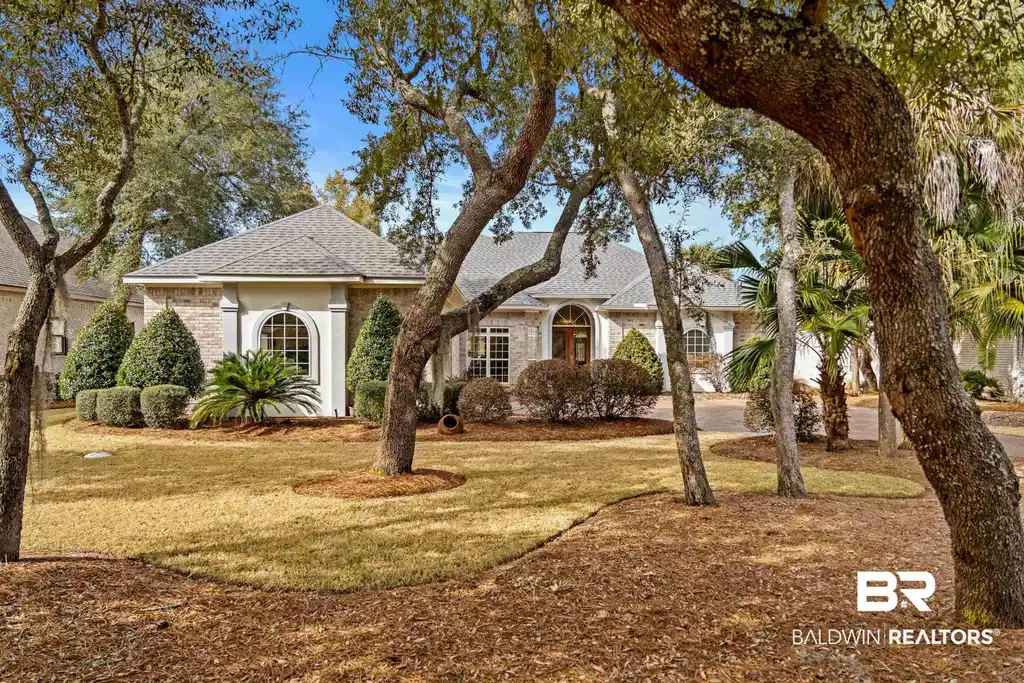 Image 1: View of front of house with brick siding, a shingled roof, and a front lawn
