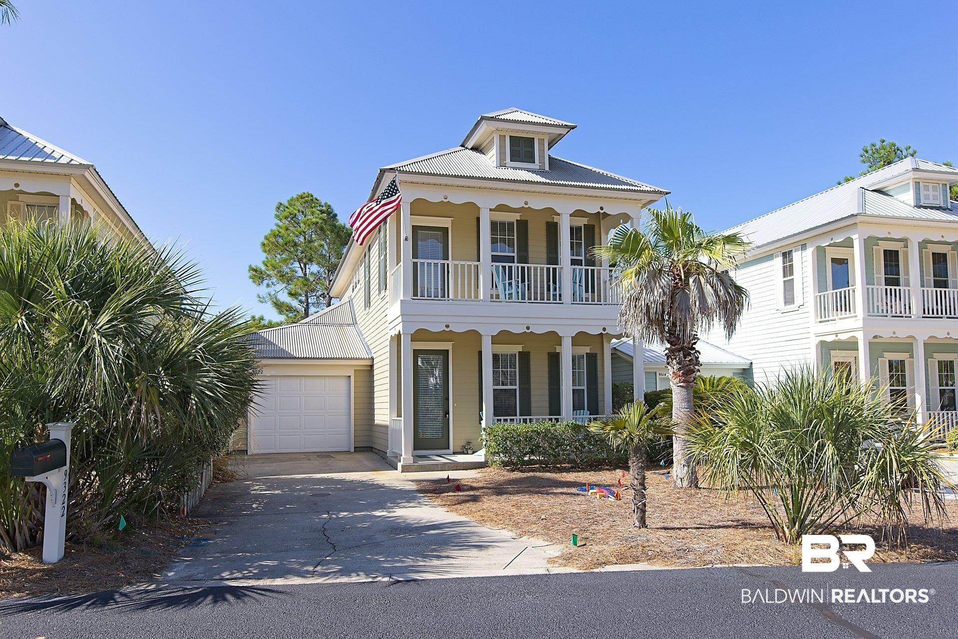 Image 1: View of front of house featuring a porch,balcony, and a single car garage