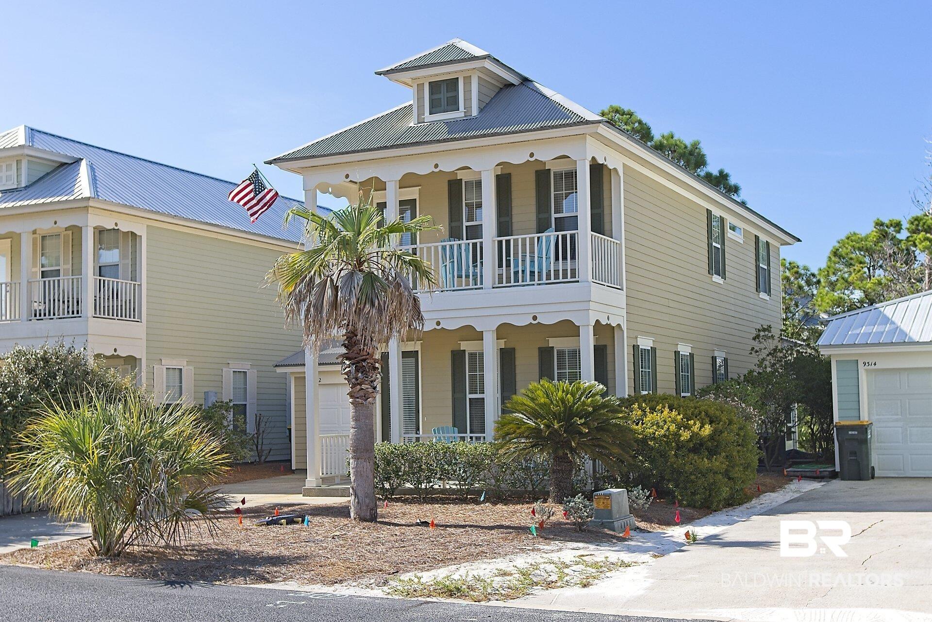 Image 3: View of front facade featuring covered porch, a garage, and concrete driveway