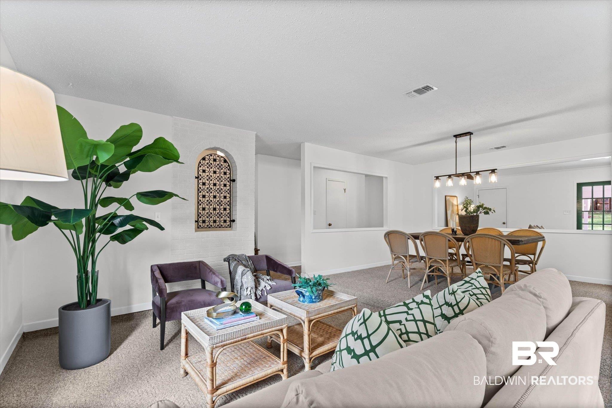 Image 4: Carpeted living area featuring a decorative wall niche with a geometric pattern