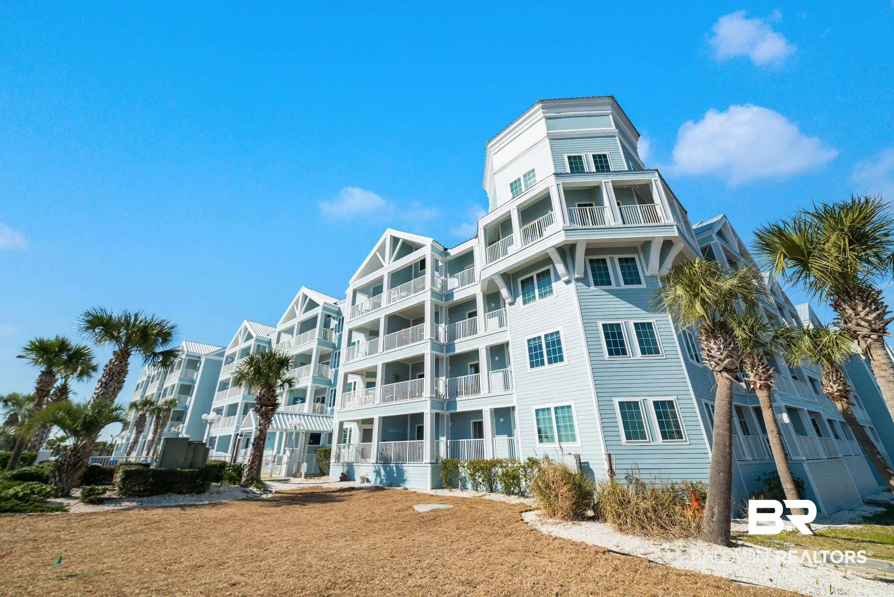 Image 1: Multi-story residential structure featuring light blue siding and white trim