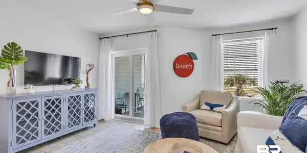 Image 4: Bright living area featuring a modern ceiling fan, large sliding glass doors, white window blinds, and tile flooring