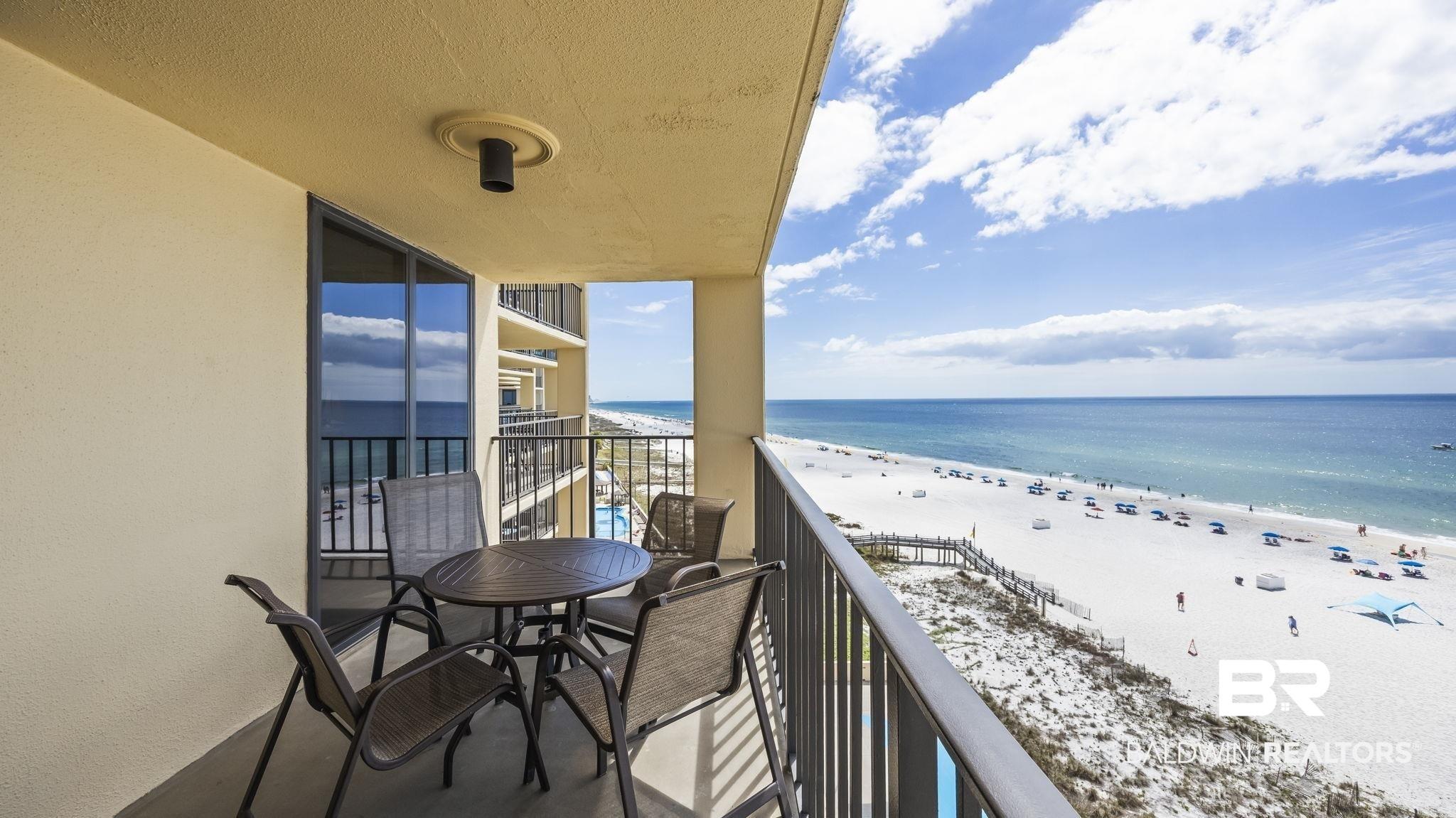 Image 4: Balcony featuring view of water and beach