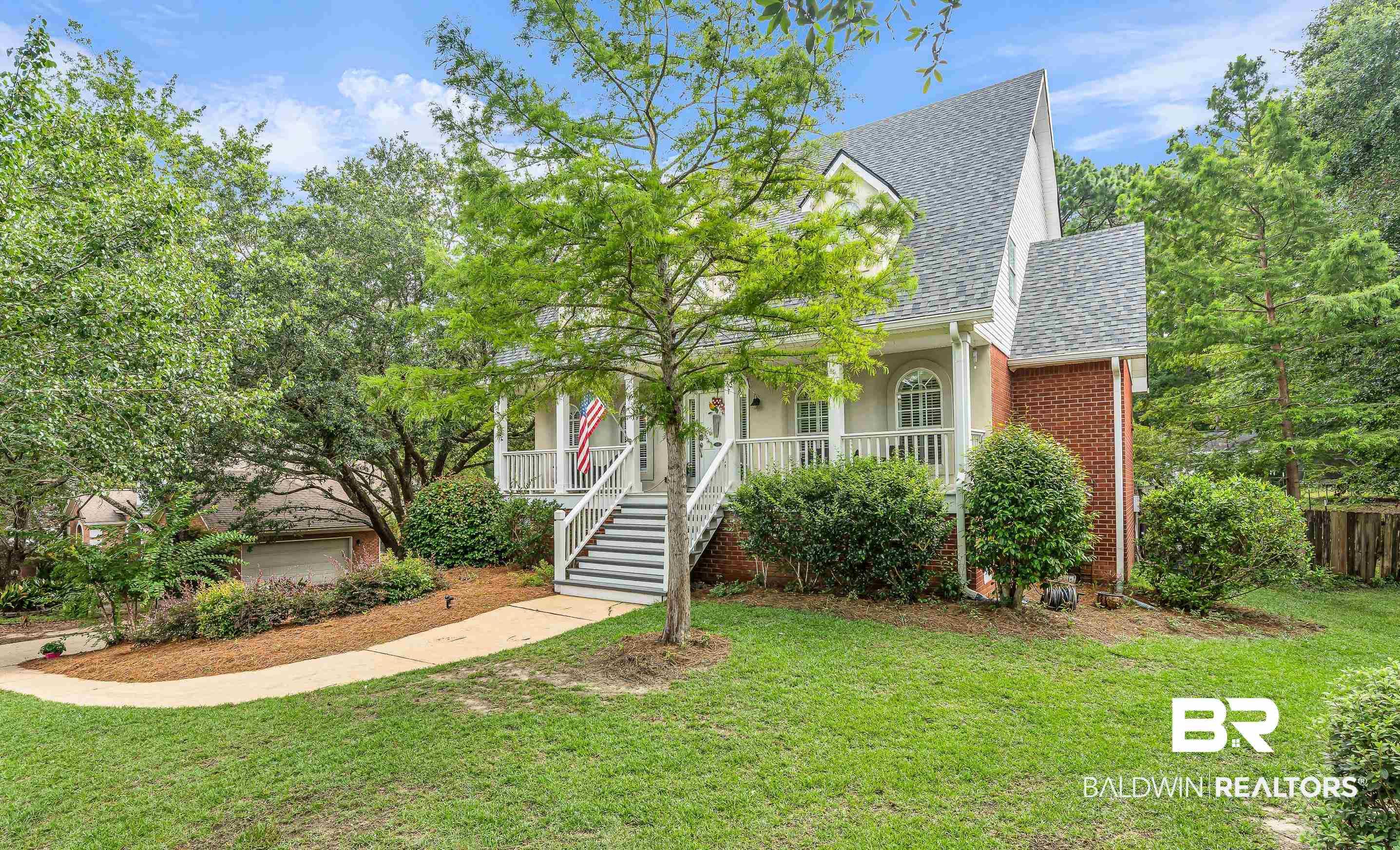 Image 3: Traditional-style residence featuring a prominent front porch with white railings and columns