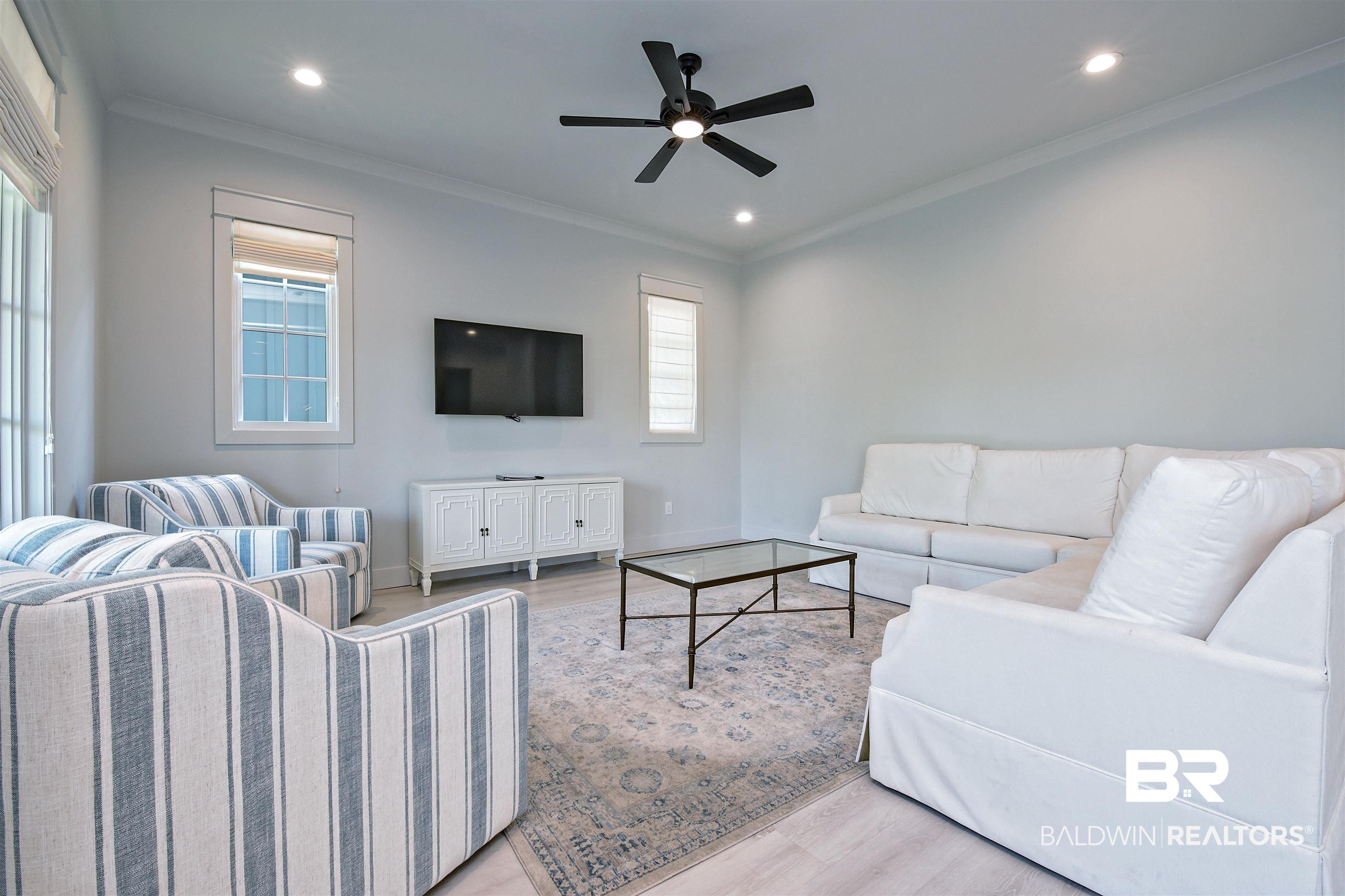 Image 3: Living area featuring light wood-finish flooring, recessed lighting, and a contemporary ceiling fan