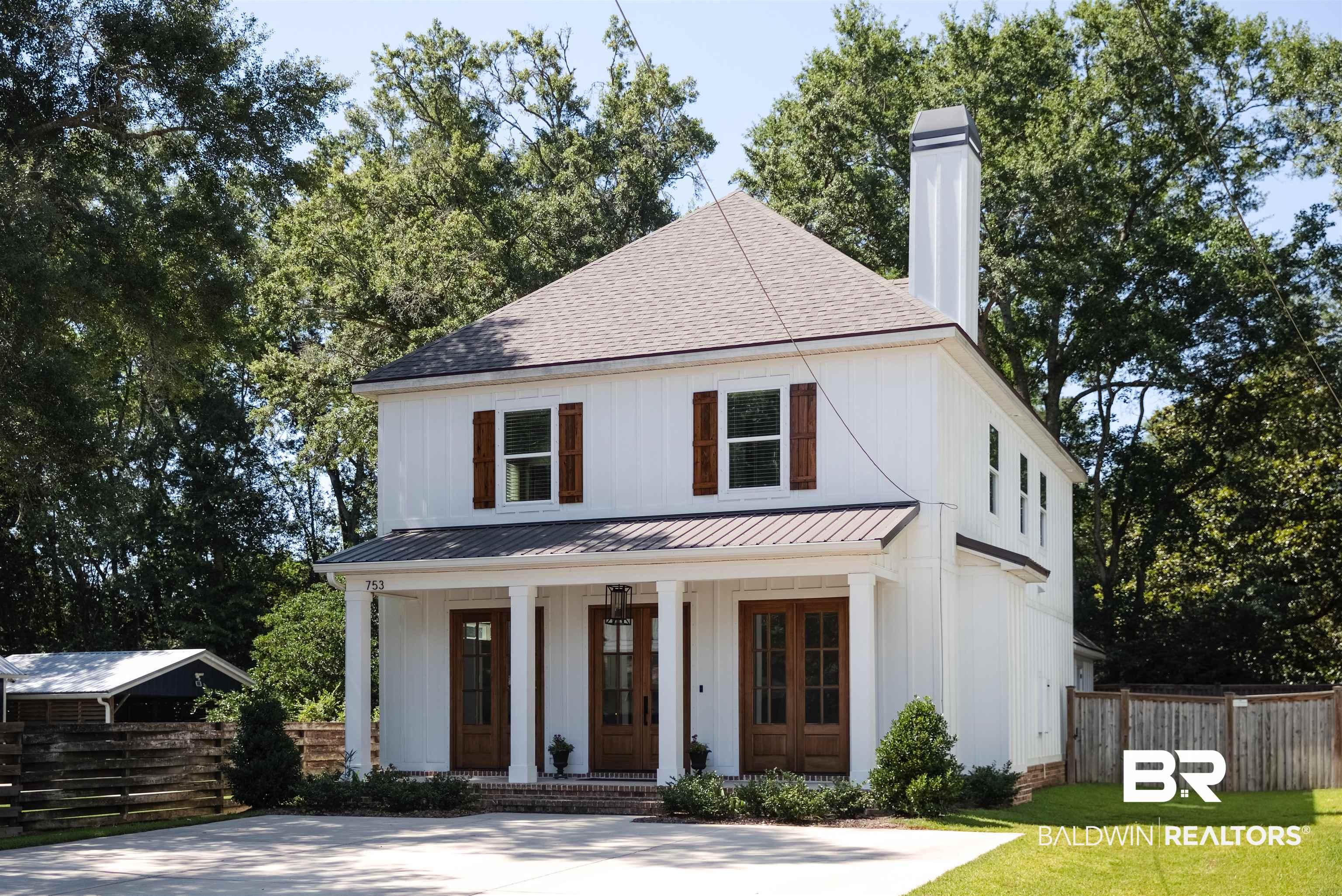 Image 2: White vertical siding exterior with a prominent chimney