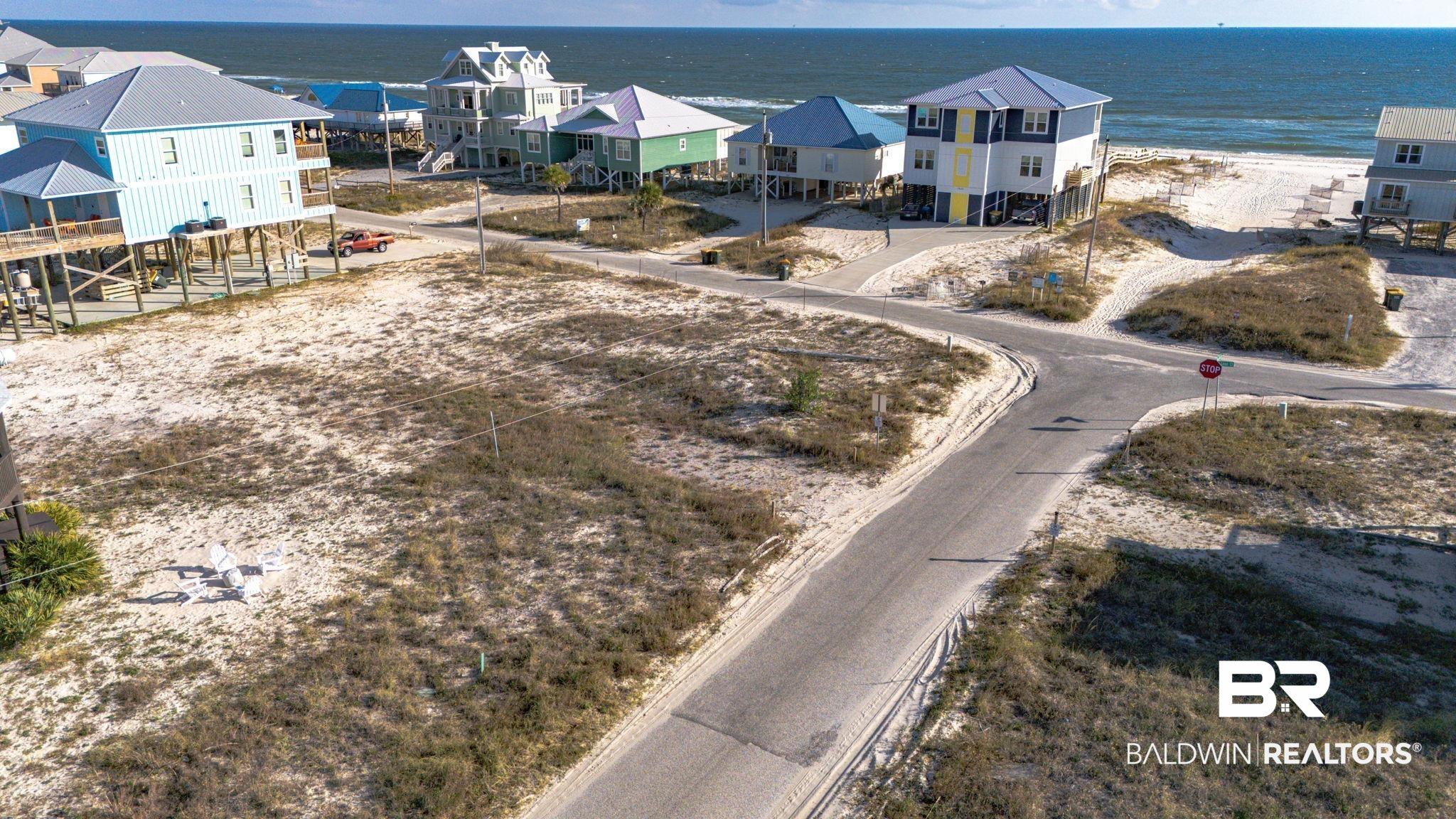 Image 2: Aerial view of residential area with a large body of water
