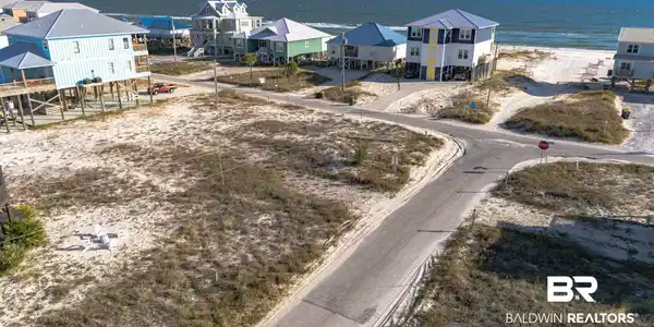 Image 2: Aerial view of residential area with a large body of water