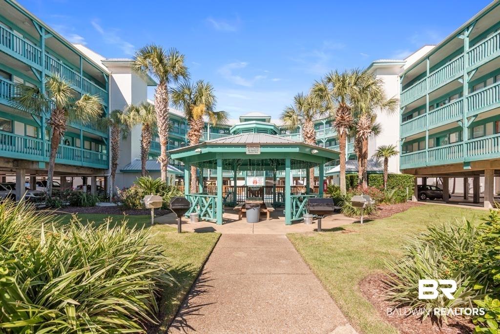Image 3: Surrounding community with a gazebo, a patio area, and a lawn