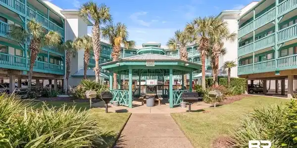Image 3: Surrounding community with a gazebo, a patio area, and a lawn