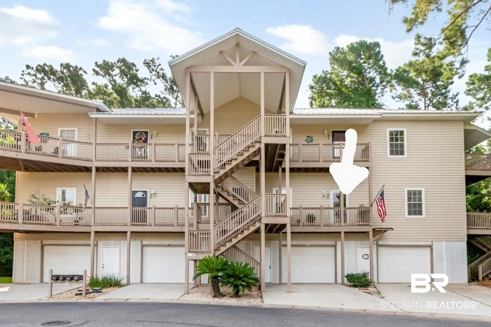 Image 1: Multi-level exterior featuring light-colored siding and multiple private balconies with wood railings