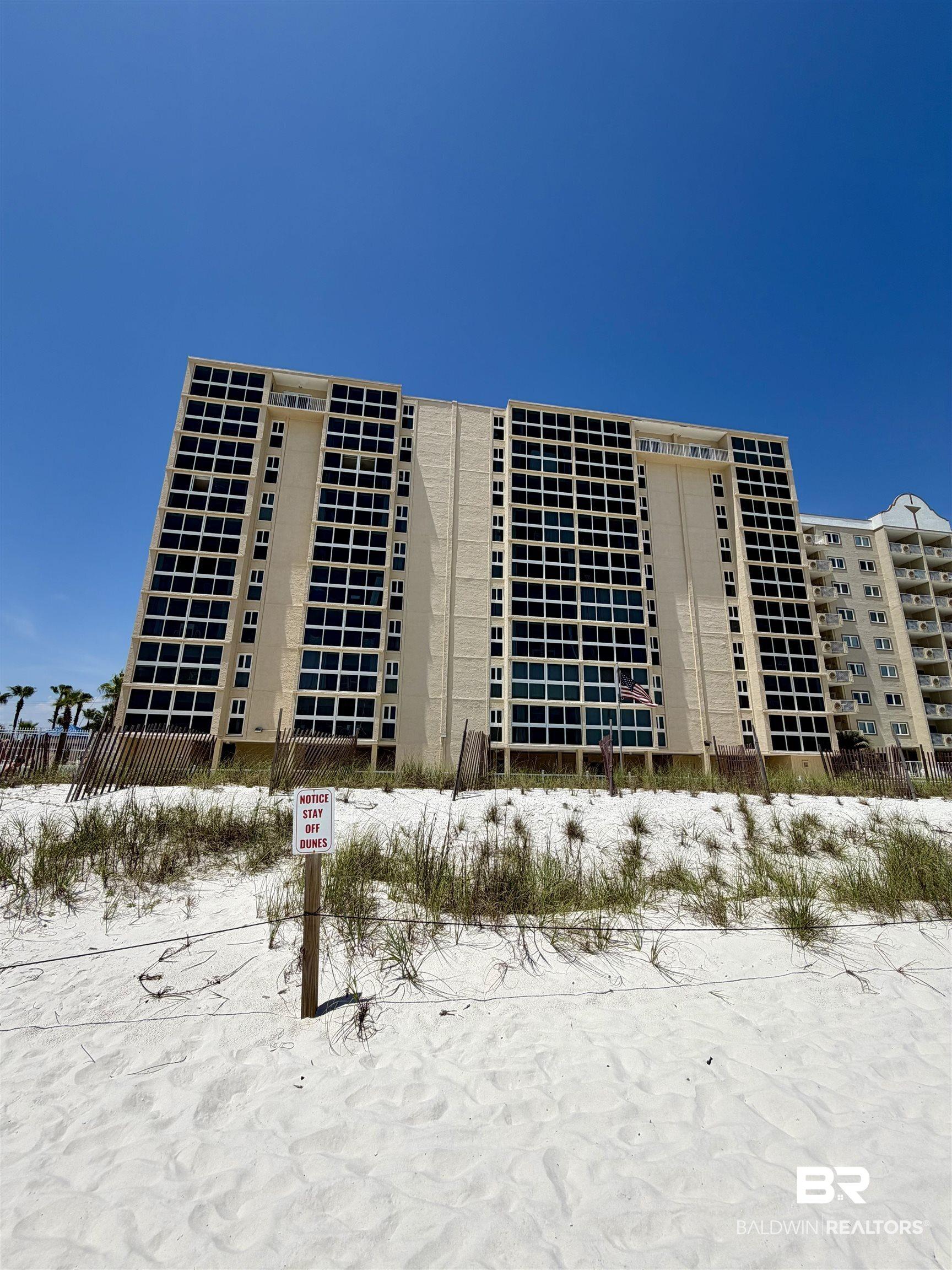Image 2: Multi-story building featuring numerous windows and private balconies