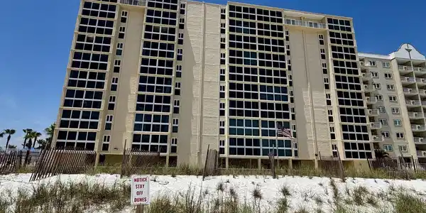 Image 2: Multi-story building featuring numerous windows and private balconies