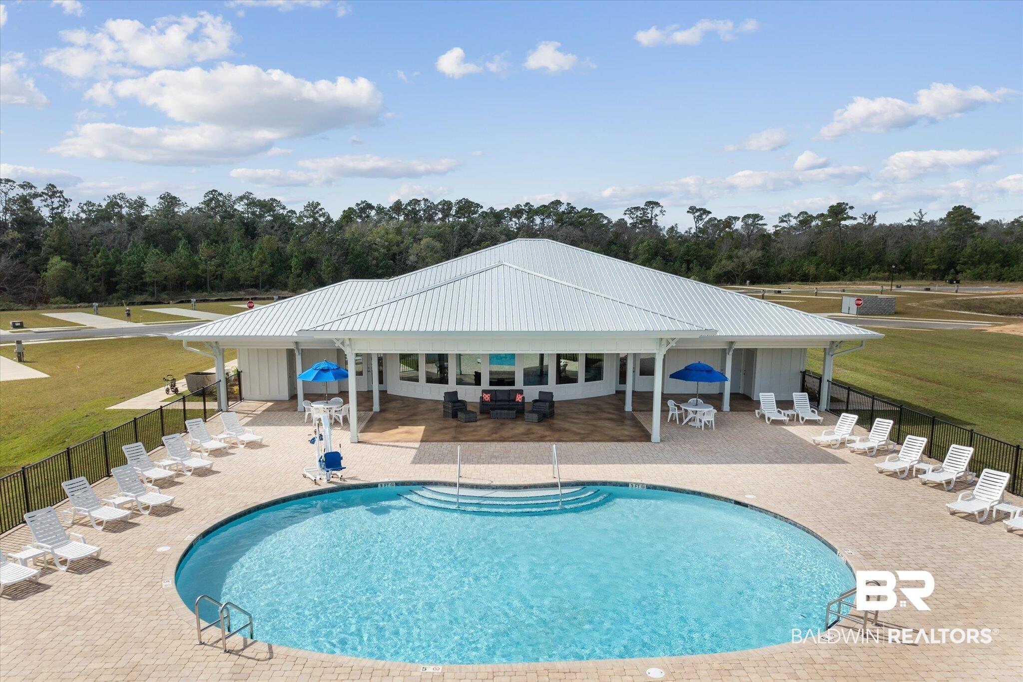 Image 4: Community pool with a patio area